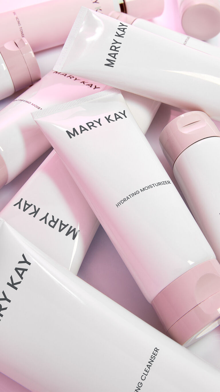 Tubes of cleansing, toner, exfoliating, and moisturizing products from Mary Kay Skin Care are stacked on top of each other.